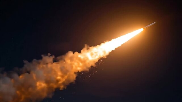 Rocket launch with bright fire trail in dark sky.