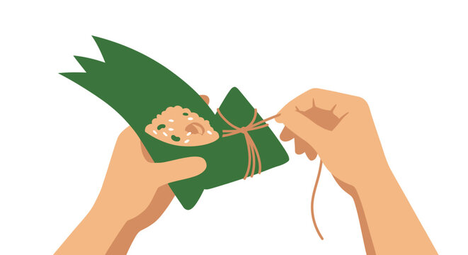 Hands wrapping traditional green dumpling with string.