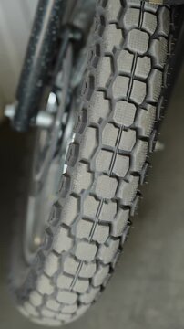  Close-up of a knobby dual-sport motorcycle tire with a blocky tread pattern