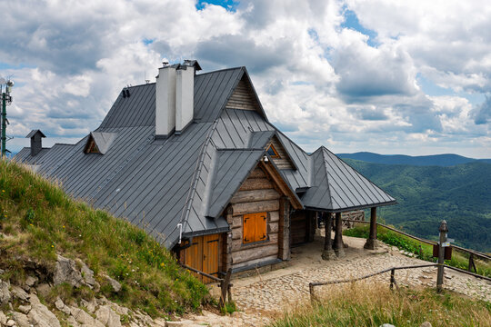 Scenic View of the Chatka Puchatka Wooden Mountain Shelter with a Grey Metal Roof in the Bieszczady Mountains in Poland under a Cloudy Sky