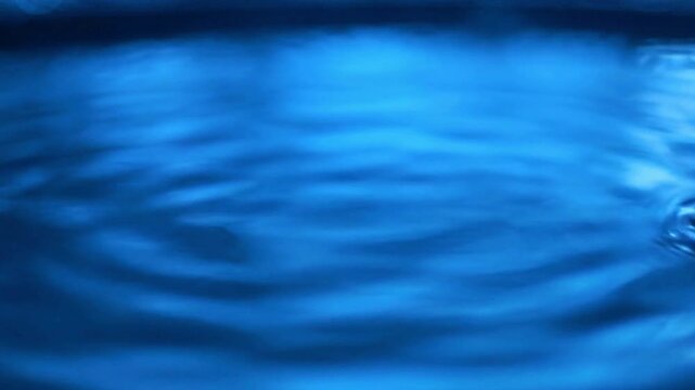 A serene body of water ripples gently in a natural setting outdoors.