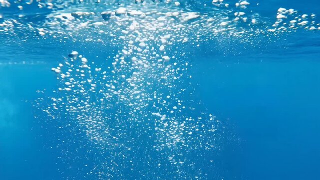 Clear blue water with rising air bubbles and calm surface light effects