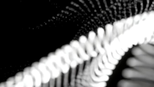 Abstract blurred white chains against a black background.