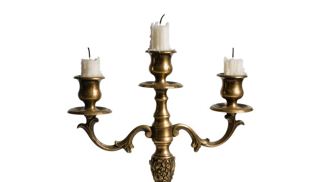 Antique brass candelabra with three unlit white candles, isolated on transparent background