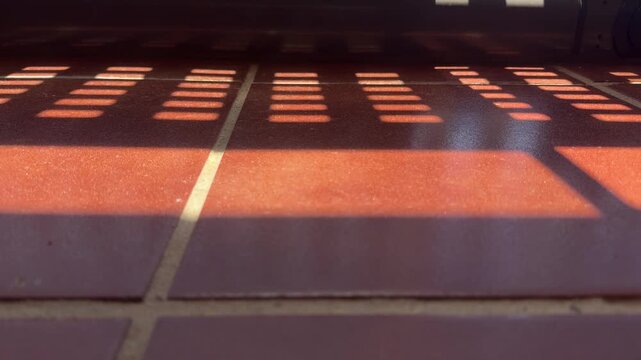 Sunlight And Shadow Patterns Moving Across Tile Floor Timelapse 4K