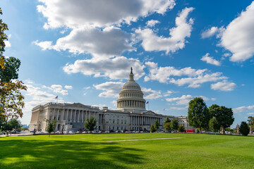 Fototapeta premium Washington DC landmark. Senate and House in Washington DC. Capitol dome. Historic Capitol by the national flag. Capitol dome as symbol of law. Washington monument architecture. Washington DC