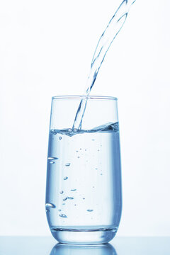 a transparent glass is filled with water creating air bubbles