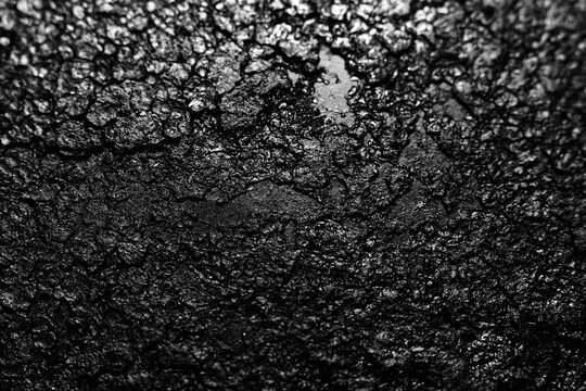 Close up of cracked and rough black cast iron textured background