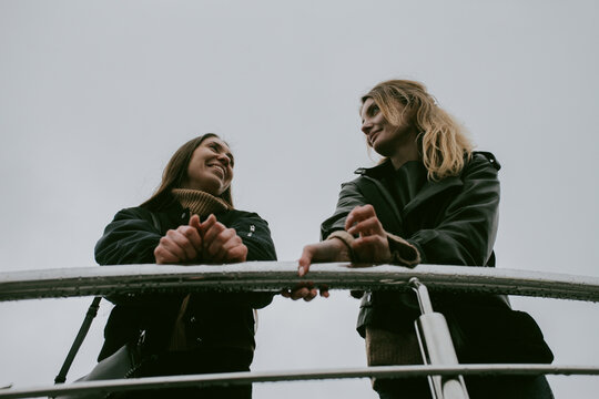 Two female friends walking outdoors on an autumn day