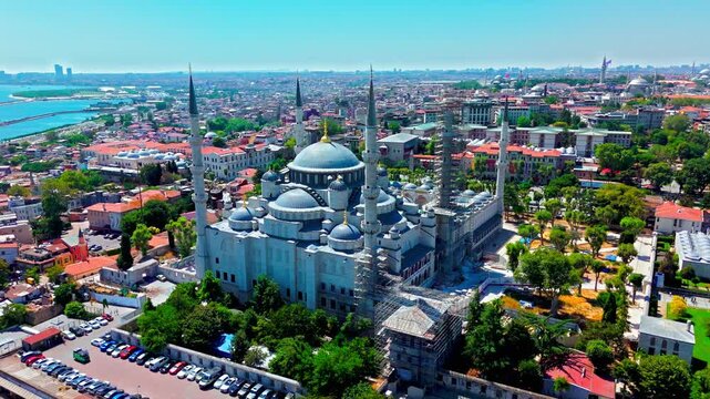 Drone view of Hagia Sophia Grand Mosque in Istanbul, Turkey. The grand mosque stands prominently with large domes, tall minarets and the Bosphorus behind.