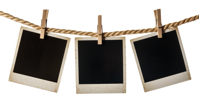 Three vintage instant photo frames hanging on a rope with clothespins, isolated on transparent background