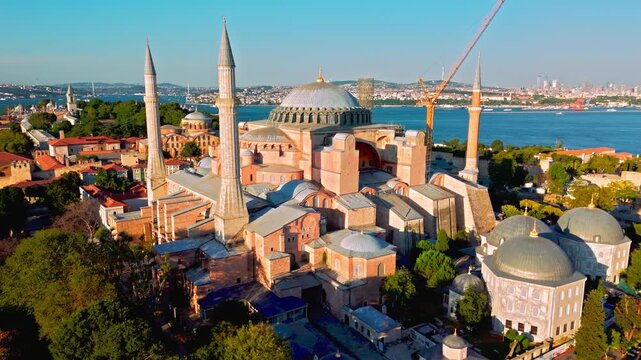 Drone view of Hagia Sophia Grand Mosque in Istanbul, Turkey. Large domes, tall minarets and warm evening light highlight the famous Sultanahmet landmark.