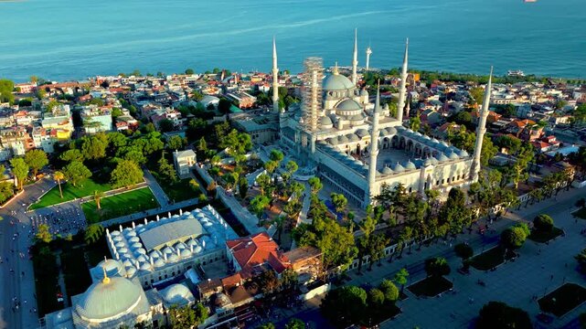 Aerial view of the Blue Mosque in Istanbul, Turkey. Sultanahmet Camii stands with grand domes, six minarets, green gardens and the Bosphorus nearby.