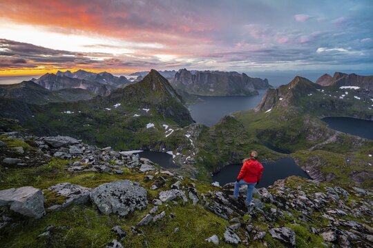 Sunset with dramatic clouds, hiker on hike to Hermannsdalstinden, lakes Krokvatnet and Tennesvatnet, mountains, Moskenes&oslash;ya, Lofoten, Nordland, Norway