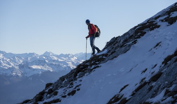 Mountaineers on the rocky summit ridge with the first snow in autumn, hiking trail to Guffert, mountain panorama in the background, Brandenberg Alps, Tyrol, Austria