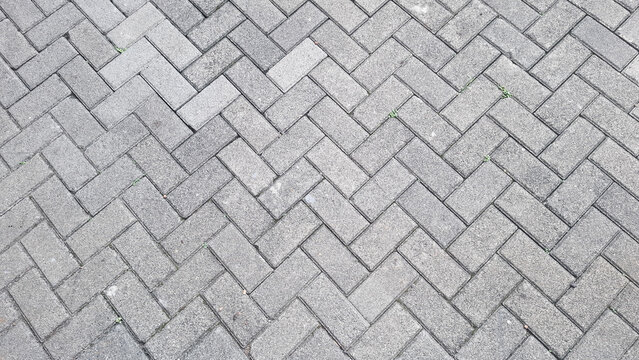 Gray interlocking brick pavement texture background pattern