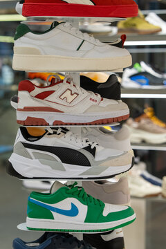 Sneakers of various brands on store shelves - Nike, Air Jordan, Puma, New Balance, Lacoste. Wide selection of athletic shoes in store. Minsk, Belarus - March 30, 2026