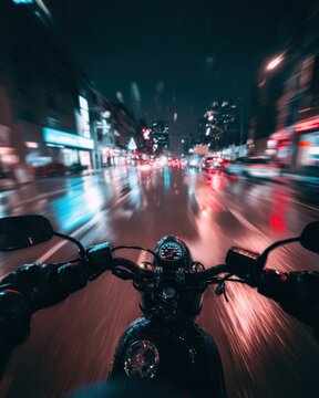 Riding Motorcycle on Wet City Street at Night