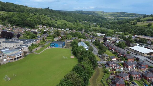 Aerial view of the village of Mytholmroyd in Calderdale showing Calder High School and houses along the Calder valley