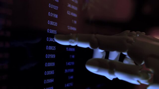 Robotic hand analyzing economic financial data from computer monitor.Close up. Futuristic AI business metaphor, dark mood office, shallow depth of field, dim light.