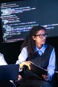 Cinematic shot of a diverse, multiethnic software team take part in the project talk in a modern technology office bathed in blue light, capturing collaboration on an inclusive (frame 825)