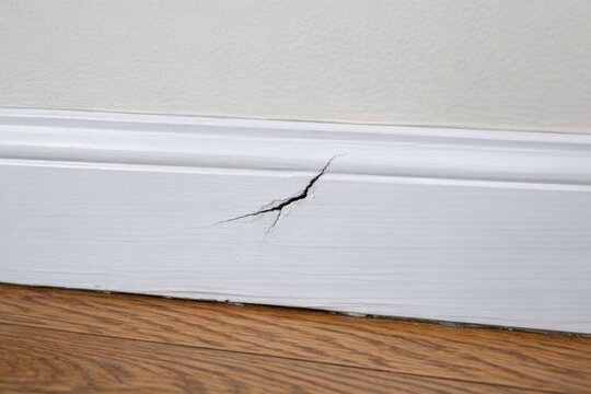 A small crack in the corner of a room, often overlooked but significant