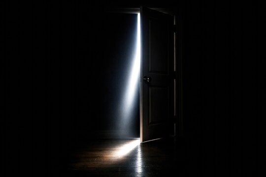 A open door in a dark room with light coming from outside, inviting and mysterious