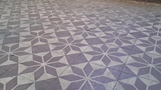 Geometric star pattern floor tiles captured in smooth motion video footage