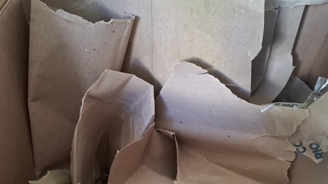 Crumpled brown paper sheets shifting inside a cardboard box video motion