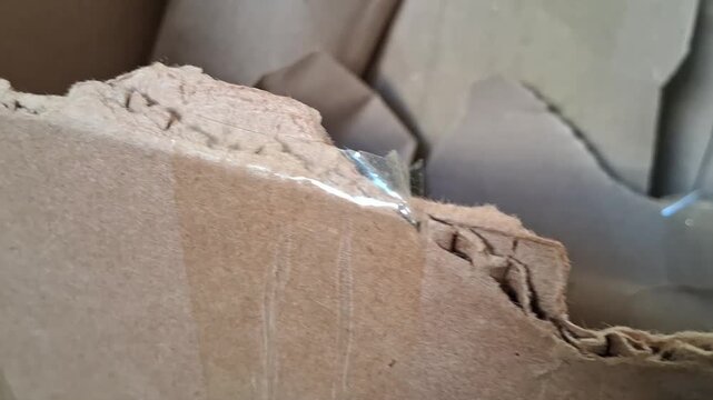 Torn brown cardboard box edges moving in smooth motion video footage