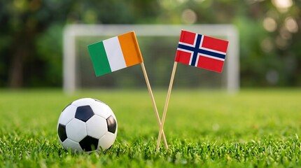 Fototapeta premium Soccer match scene with flags of Ivory Coast and Norway on a grassy field