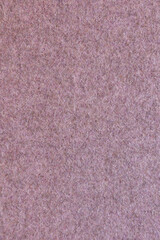 Fototapeta premium Close-up of traditional Portuguese burel wool fabric texture in a soft dusty pink color. The natural felted wool surface displays a dense, uniform fiber structure, making it an ideal seamless