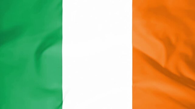 Ireland flag waving in wind slow motion seamless loop closeup, Seamless loop of a waving ireland flag fabric in slow motion.