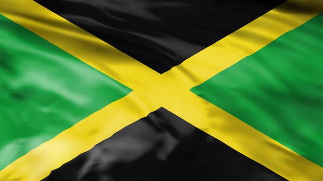 Jamaican national flag waving gracefully in smooth wind motion.
