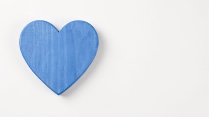 Obraz premium Blue wooden heart shape isolated on a plain white background