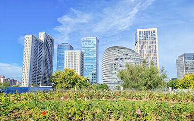 Fototapeta premium Architectural abstract close-up view of the modern curved facade of Chengao Mansion and a glass skyscraper in the Olympic Business District, Chaoyang, Beijing, China