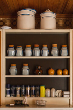 Kitchen shelves with spices and grains jars and pots