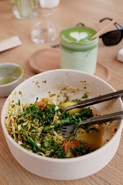 Closeup overview of a plate with food leftovers and matcha drink 