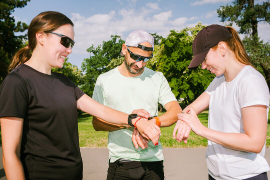 Runners check their stats on their smartwatches after a workout.
