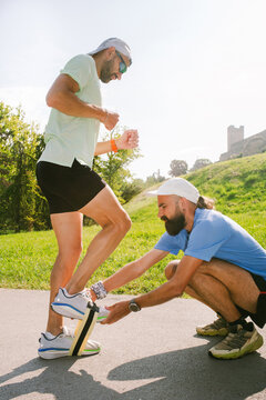 A running coach assists a client during a training session