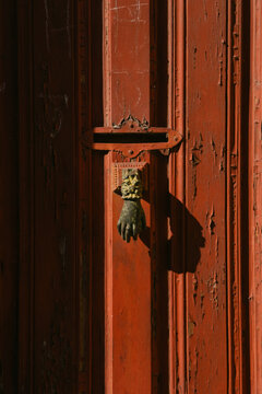 brass hand/ knocker on door 