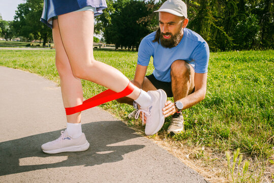 A running coach assists a client during a training session