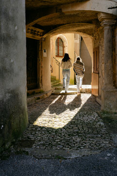 two young women walking in village in the South of France