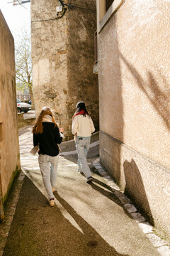two young women walking in village in the South of France