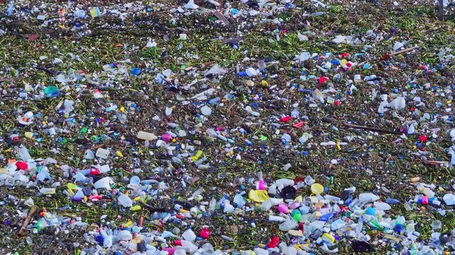Disturbing scenes of Plastic waste and household garbage floating on the sea surface, ocean pollution concept.,  polluted beach, Plastic marine debris. severe environmental impact of marine pollution 