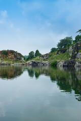 Fototapeta premium Tarpania Lake, Marble Lake, Blue Dam, Patal Dam or Durga Bera,a scenic lake in the Ajodhya Hills of Purulia, West Bengal, India. Deep blue water surrounded by sharp, white, marble-like rocky cliffs.
