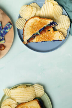 Ube gouda cheese and bacon grilled cheese and chips, vertical