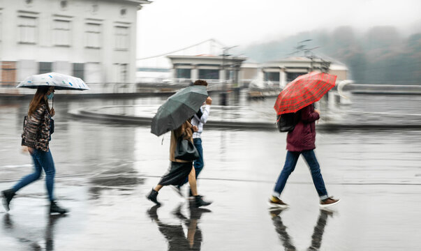 Defocused image of people with umbrellas