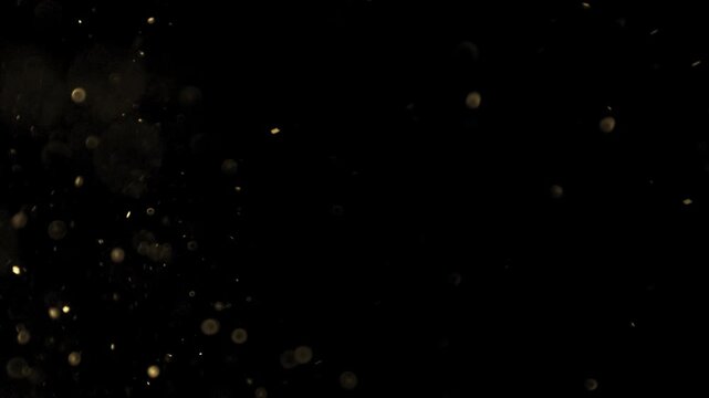 Gold ink in water shooting with high speed camera. Gold glitter background with sparkle shine light confetti. Super Slow Motion at 1000fps. effect.