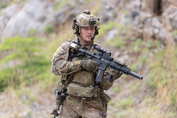 Fototapeta premium Military participate in a patrol in a rocky terrain